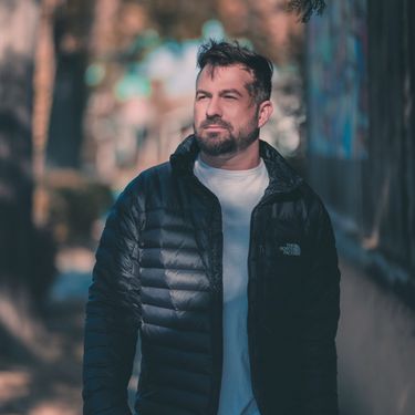 Handsome Christian single man wearing a black jacket