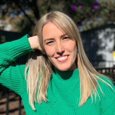 Cute Christian single blonde woman wearing a green sweater