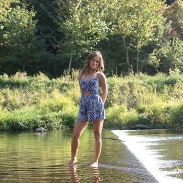 Beautiful Christian single girl standing in a stream of water